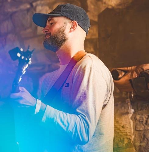 Nimai is using a holographic sticker with her camera to create the colorful light effects.